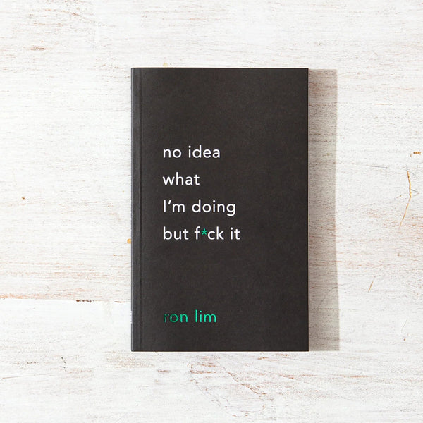 A black paperback book titled 'no idea what i'm doing but f*ck it' by Jon Lim, placed flat on a light, distressed wood background.