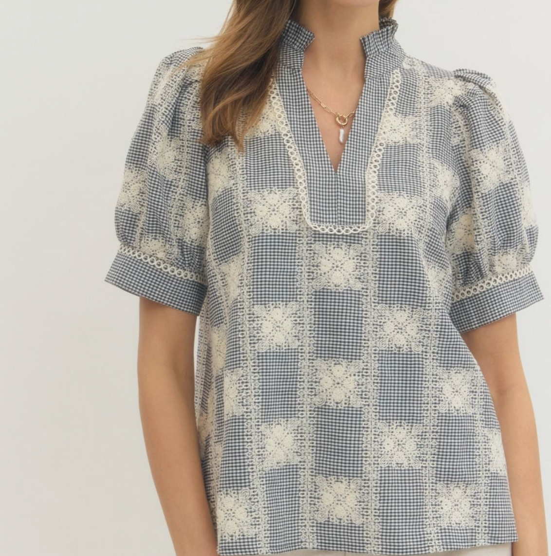 Gingham puff sleeve top with V-cut opening.